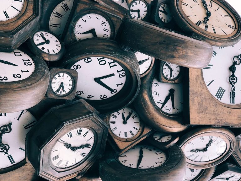 Picture of multiple clocks all piled up