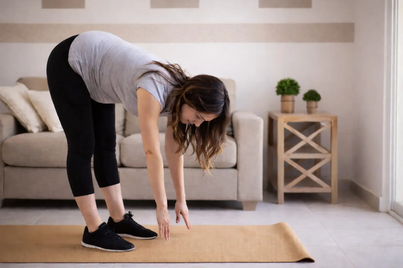 a woman stretching her back and neck